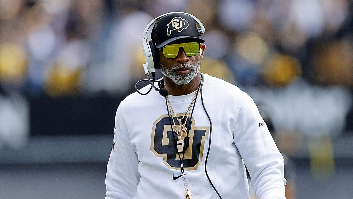 Deion Sanders looks on