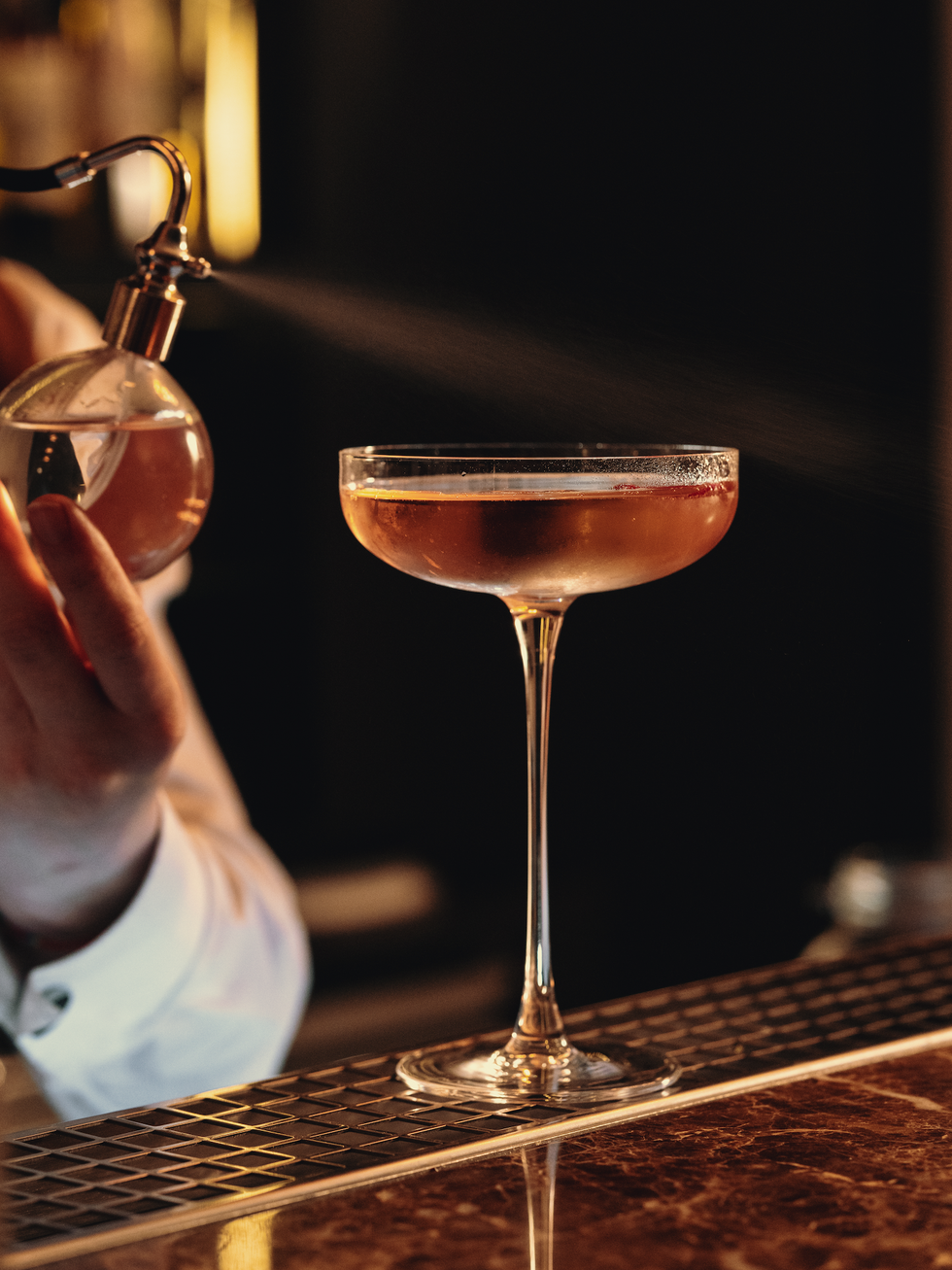 a cocktail being prepared at gaia bar on lake como