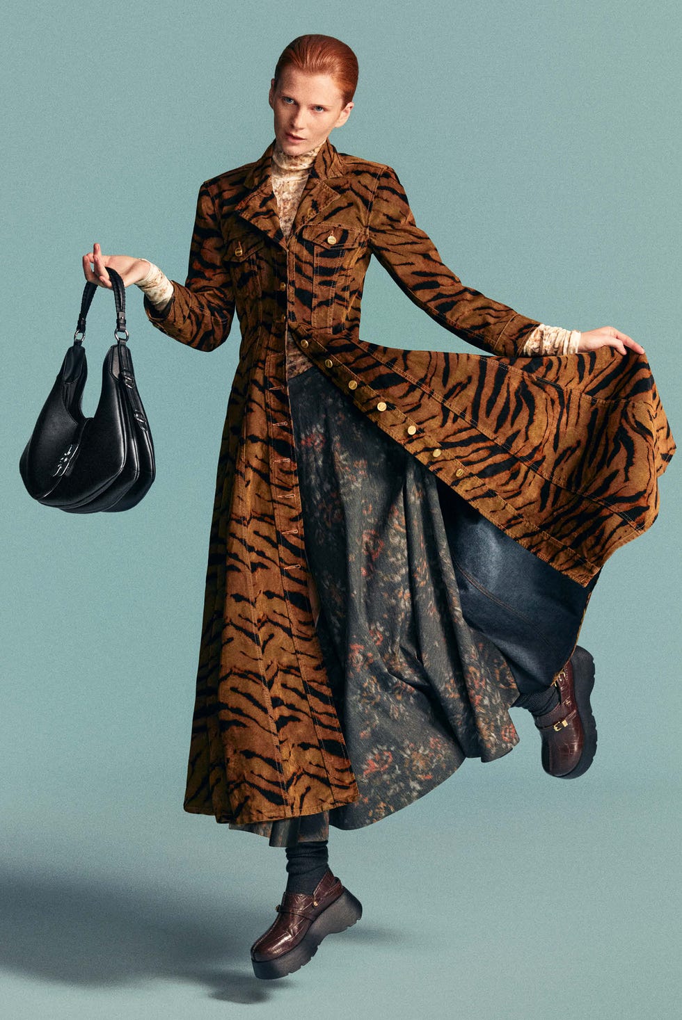 fashionable model wearing a tigerstriped overcoat and a black handbag