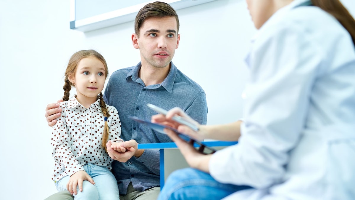 Girl with dad at doctor office