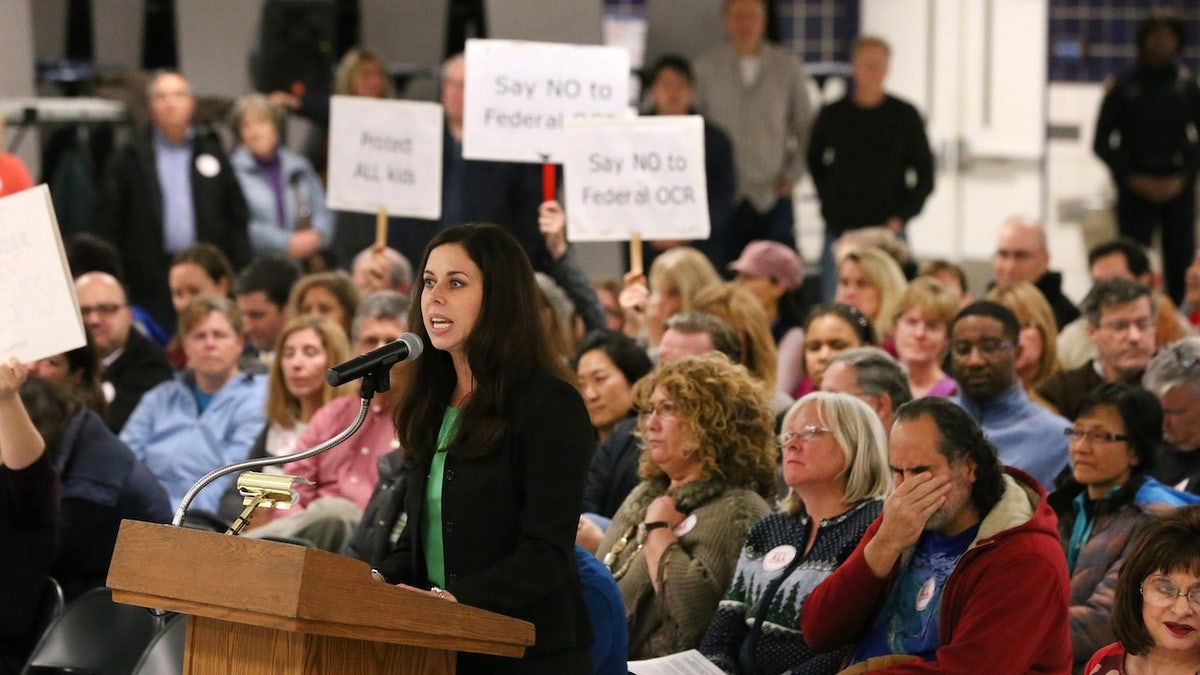Tracey Salvatore, of Schaumburg, speaks Dec. 2 during a special District 211 board meeting at Conant High School in Hoffman Estates to consider a setlement in the case of a transgender student seeking locker room access. (Chris Sweda/Chicago Tribune/TNS)