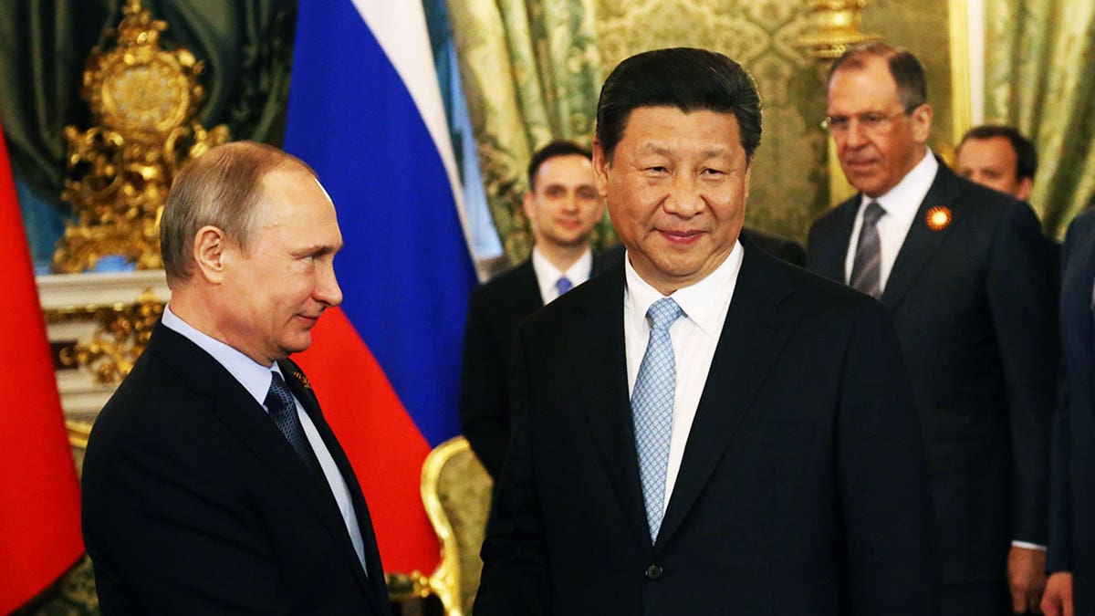 Lavrov watches Putin and Xi