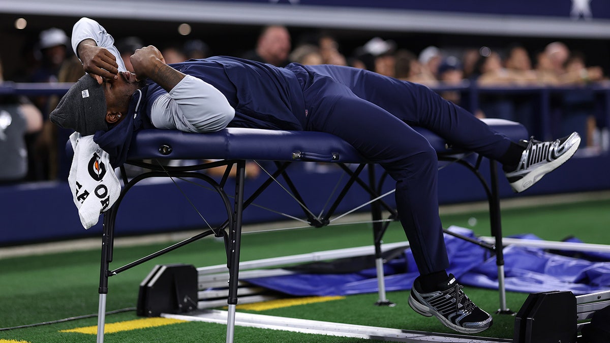 Micah Parsons lays on the training table