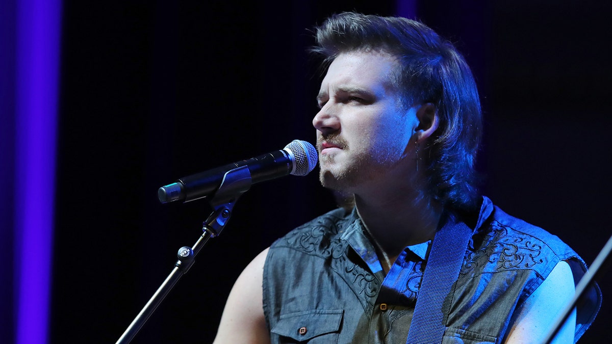 Morgan Wallen wears denim vest on stage