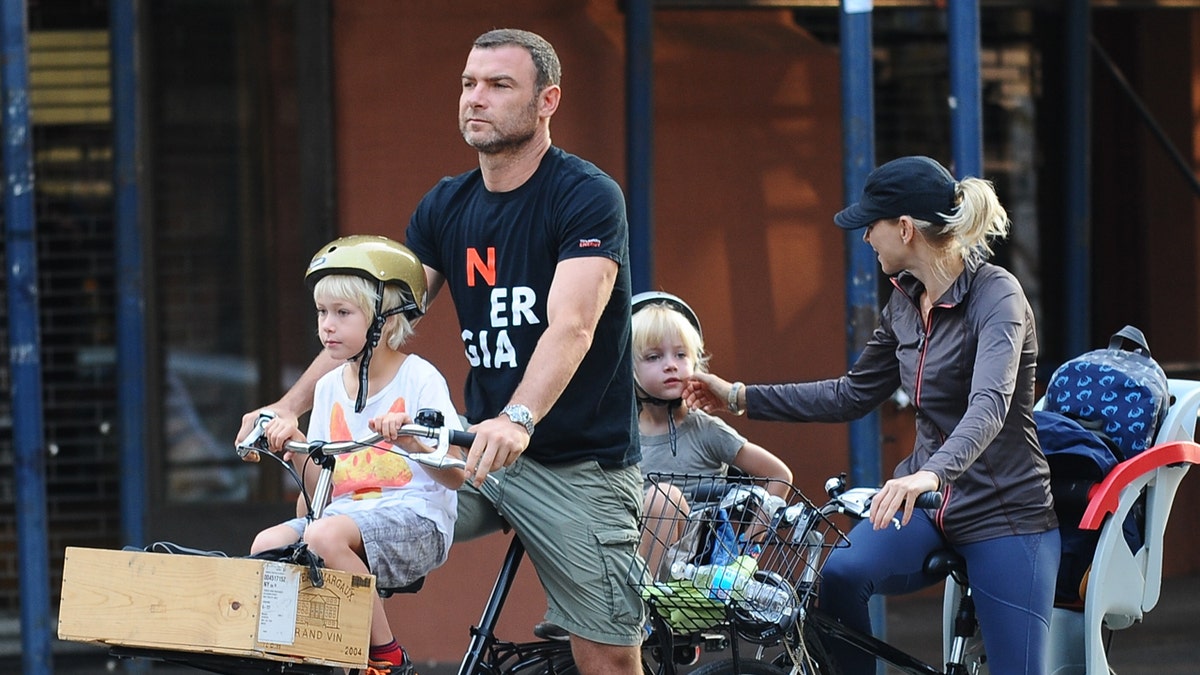 Liev Schreiber and Naomi Watts ride bikes with their children