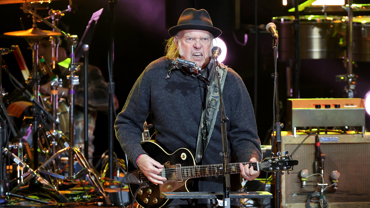 Neil Young performs on stage