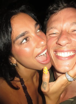 two friends posing together with a vibrant nightlife atmosphere