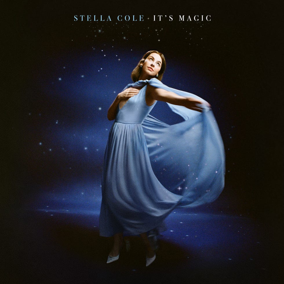 album cover featuring a figure in a blue dress in a starry background