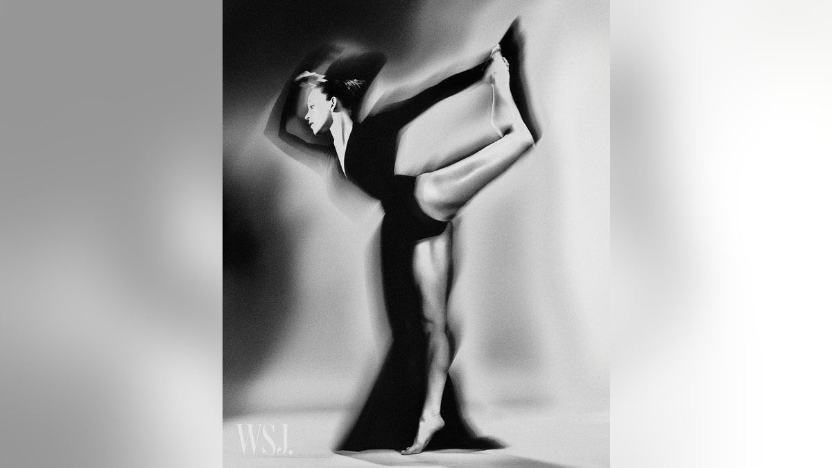 Sydney Sweeney doing an arabesque in a black dress for WSJ