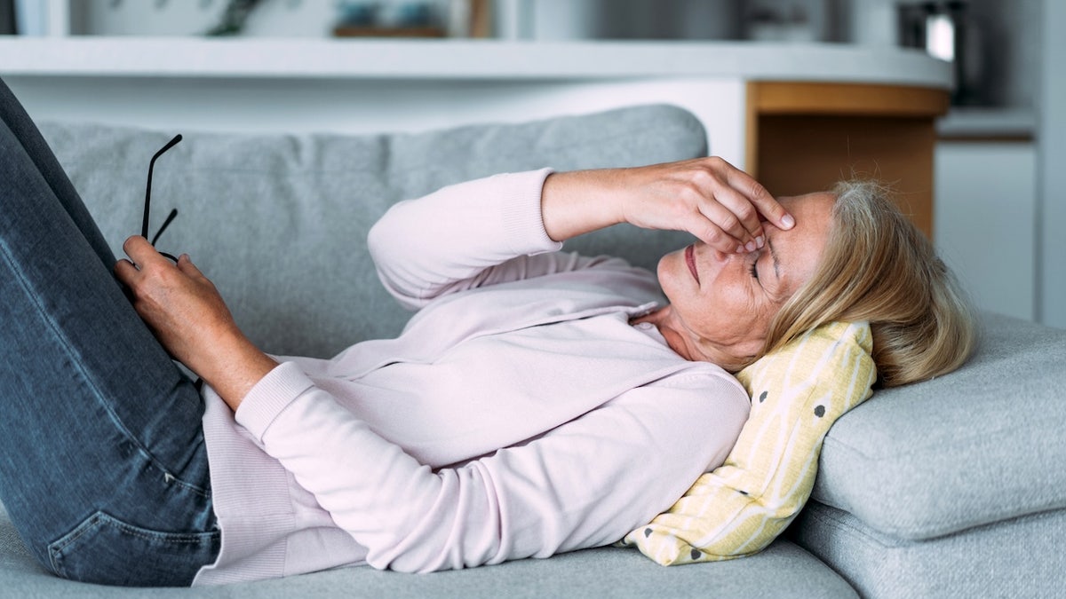 Tired older woman on couch