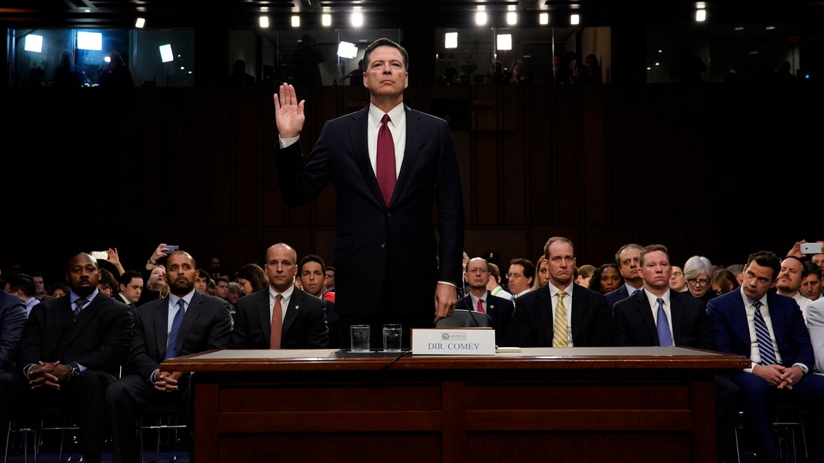 Former FBI Director James Comey is sworn in prior to testifying before a Senate Intelligence Committee hearing on Russia's alleged interference in the 2016 U.S. presidential election on Capitol Hill in Washington, U.S., June 8, 2017. REUTERS/Jonathan Ernst - RTX39NPQ