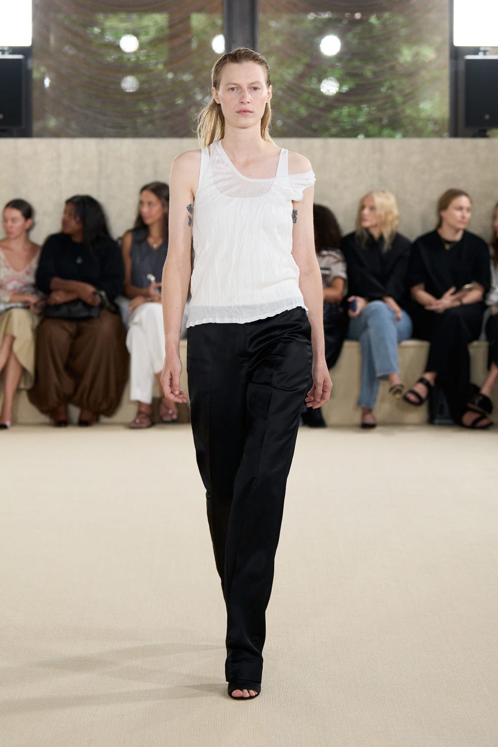 fashion model walking on the runway showcasing a trendy outfit