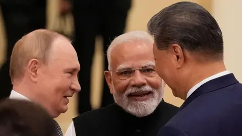 Getty Images In this picture, Indian Prime Minister Narendra Modi, in the centre of the frame, talks with Russian President Vladimir Putin on his left and Chinese President Xi Jinping, ahead of the Shanghai Cooperation Organization (SCO) Summit 2025 at the Meijiang Convention and Exhibition Centre on September 1, 2025 in Tianjin, China.