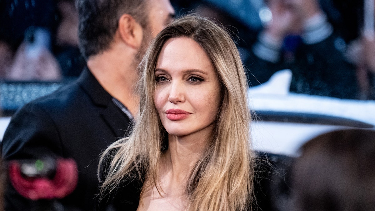 Angelina Jolie walks red carpet wearing black blazer