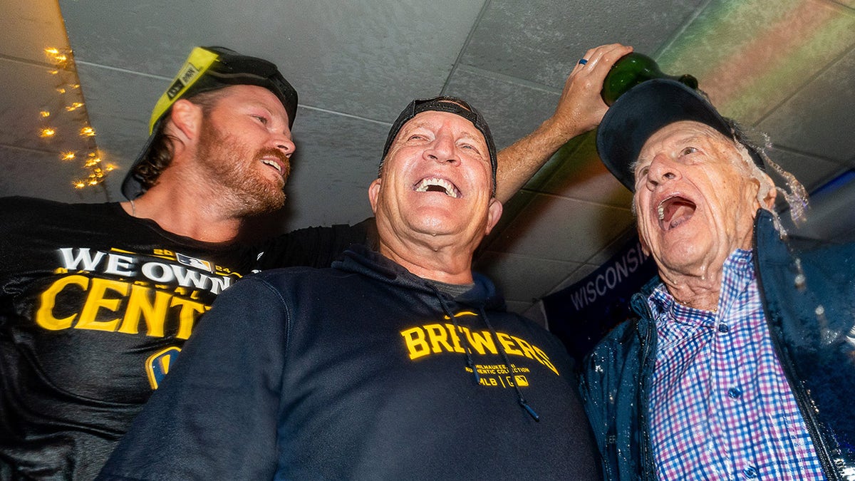 Brandon Woodruff pours champagne on Bob Uecker