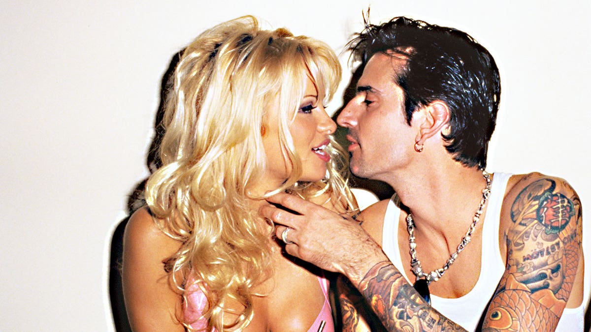 Pamela Anderson and Tommy Lee leaning in for a kiss.