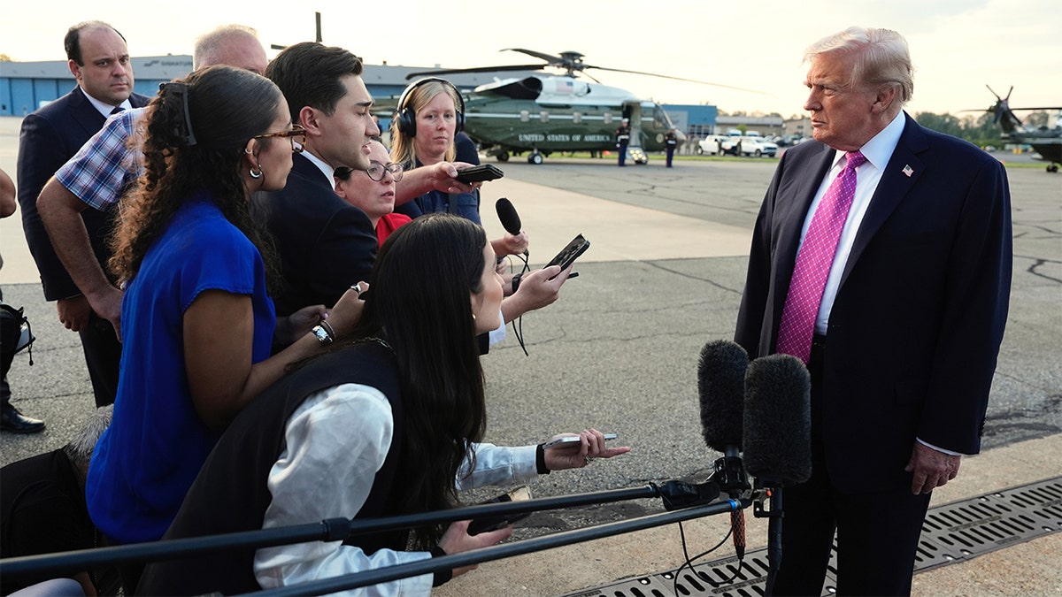 President Donald Trump holds a gaggle