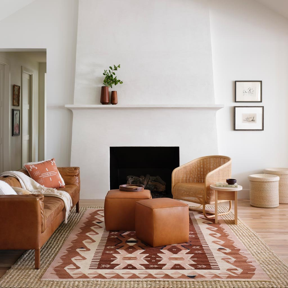 cozy living room featuring a fireplace leather furniture and decorative elements