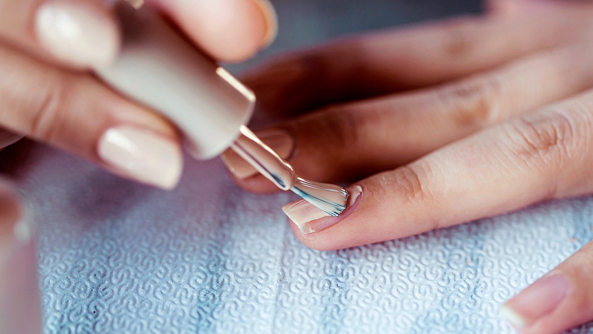 Beautiful manicured woman's nails with cream nail
