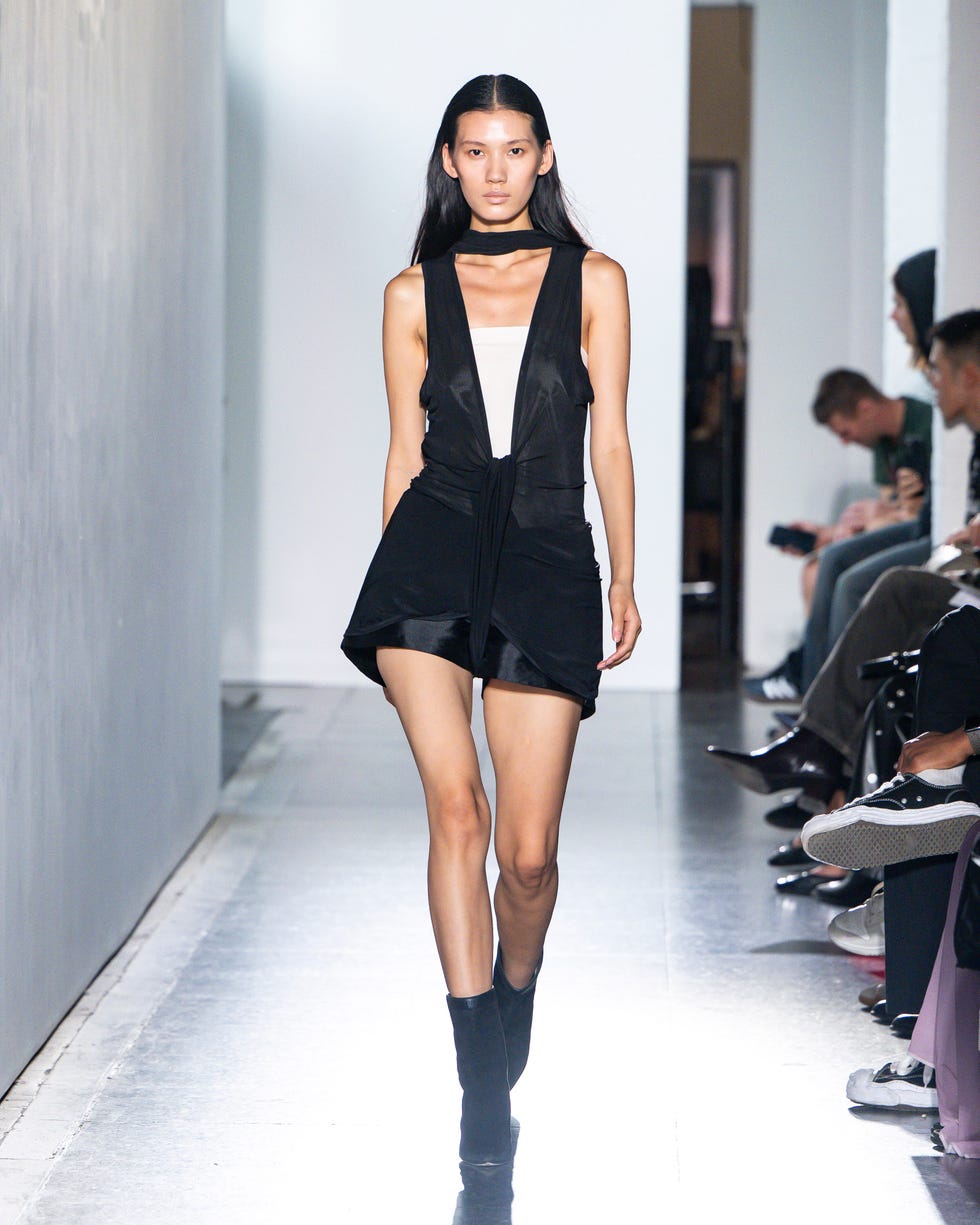 model walking on the runway showcasing a fashion outfit