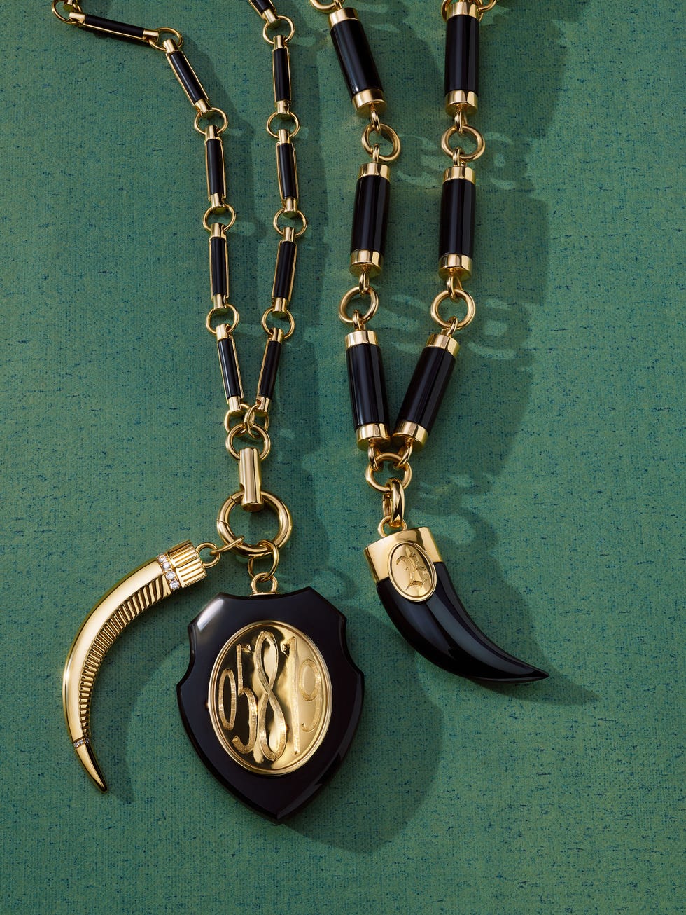 two necklaces featuring gold and black elements with unique pendants