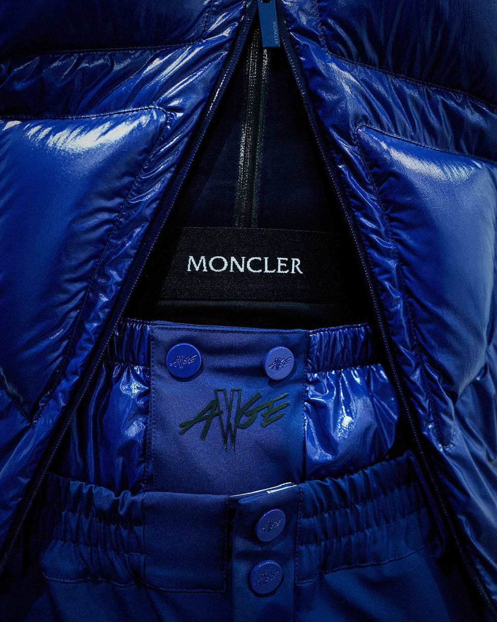 combination of a blue puffer jacket and matching pants featuring branding elements