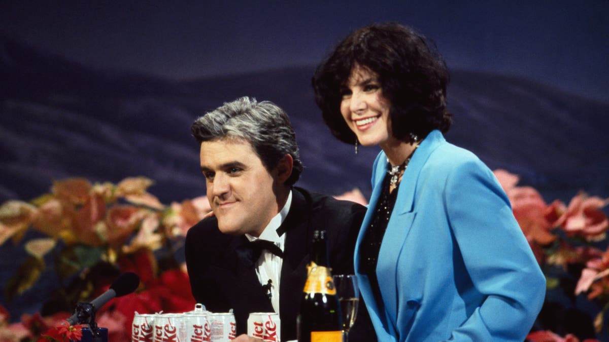 Jay Leno and his wife Mavis smiling while on the Tonight Show in 1992. 