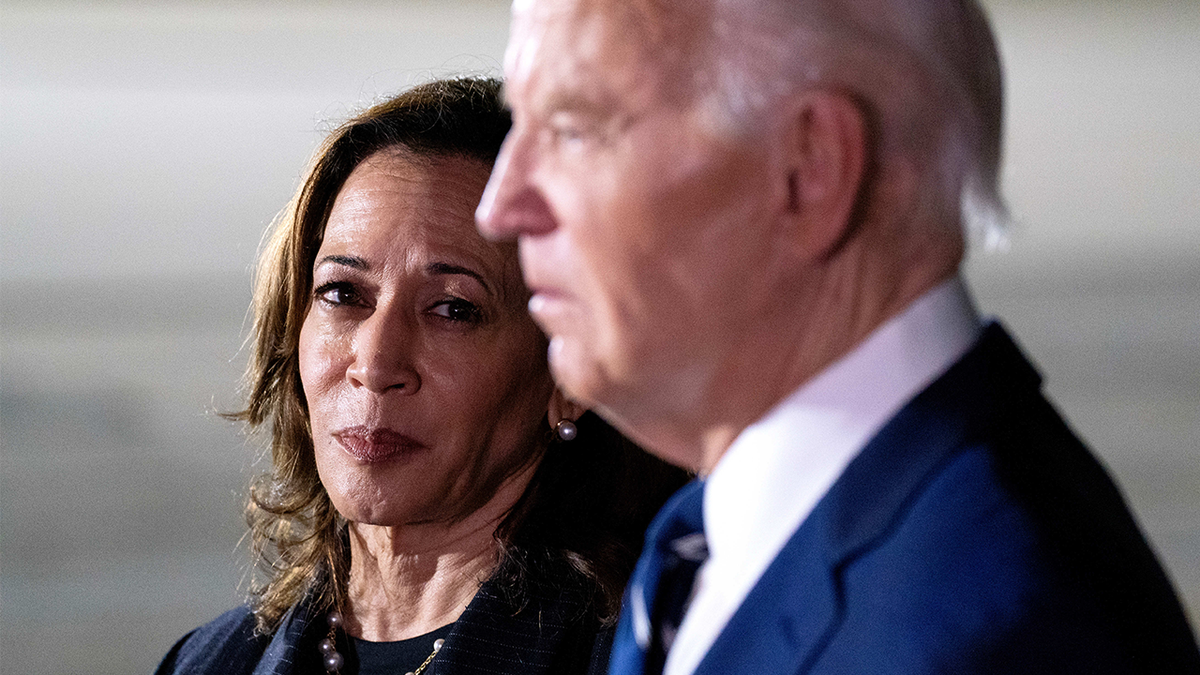 Kamala Harris looking at Joe Biden during a press event in 2024