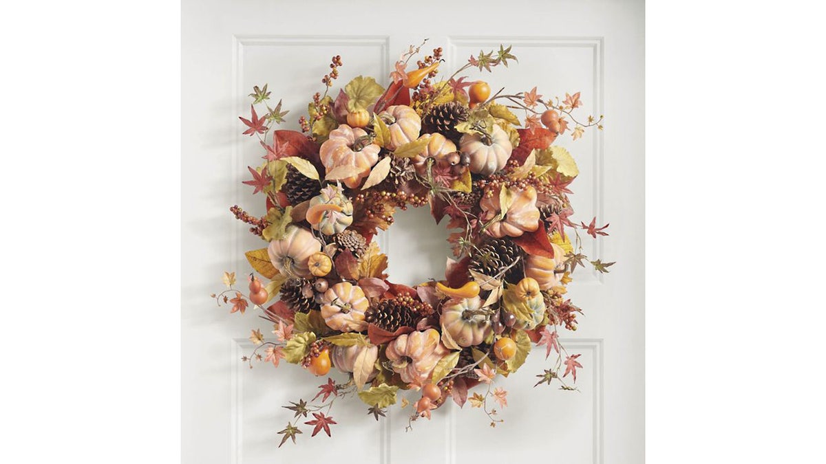 This wreath is packed with pinecones, maple leaves, berry clusters and gourds.