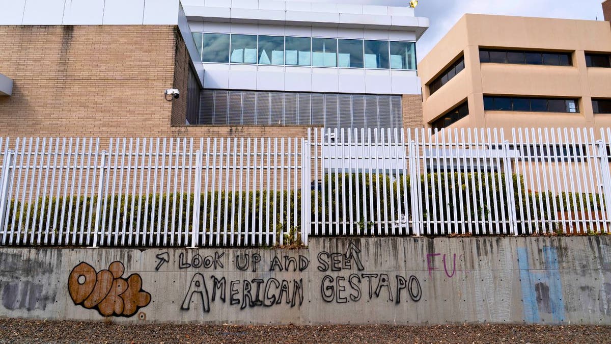 Graffiti on wall outside Portland ICE facility.