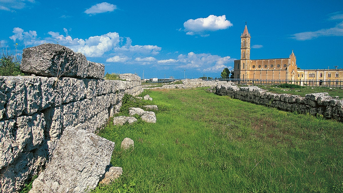 A stretch of the Messapian walls, 5th-3rd century BC, in the background the church of Sant'Antonio