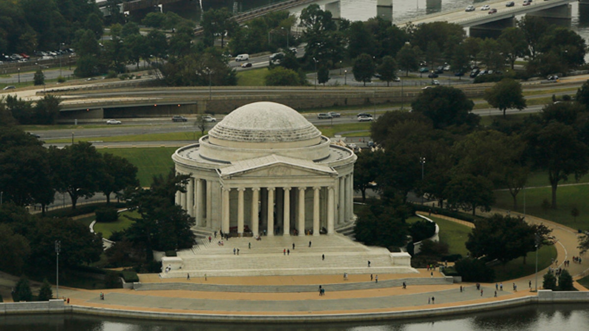 The Jefferson Memorial is surrounded by the Tidal Basin (bottom), and the Potomac River (top) in Washington October 1, 2014. Photograph taken from atop the Washington Monument. REUTERS/Gary Cameron (UNITED STATES) - RTR48Q3E