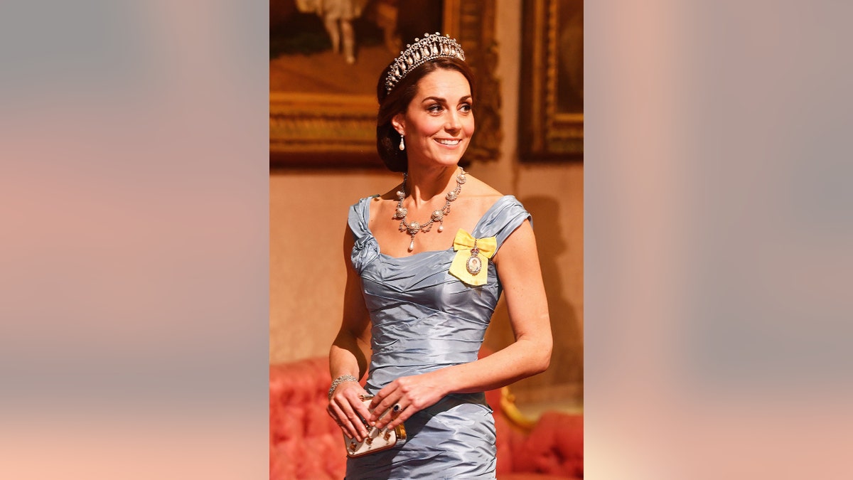 Kate Middleton wearing a satin pale blue gown with jewels and a tiara.