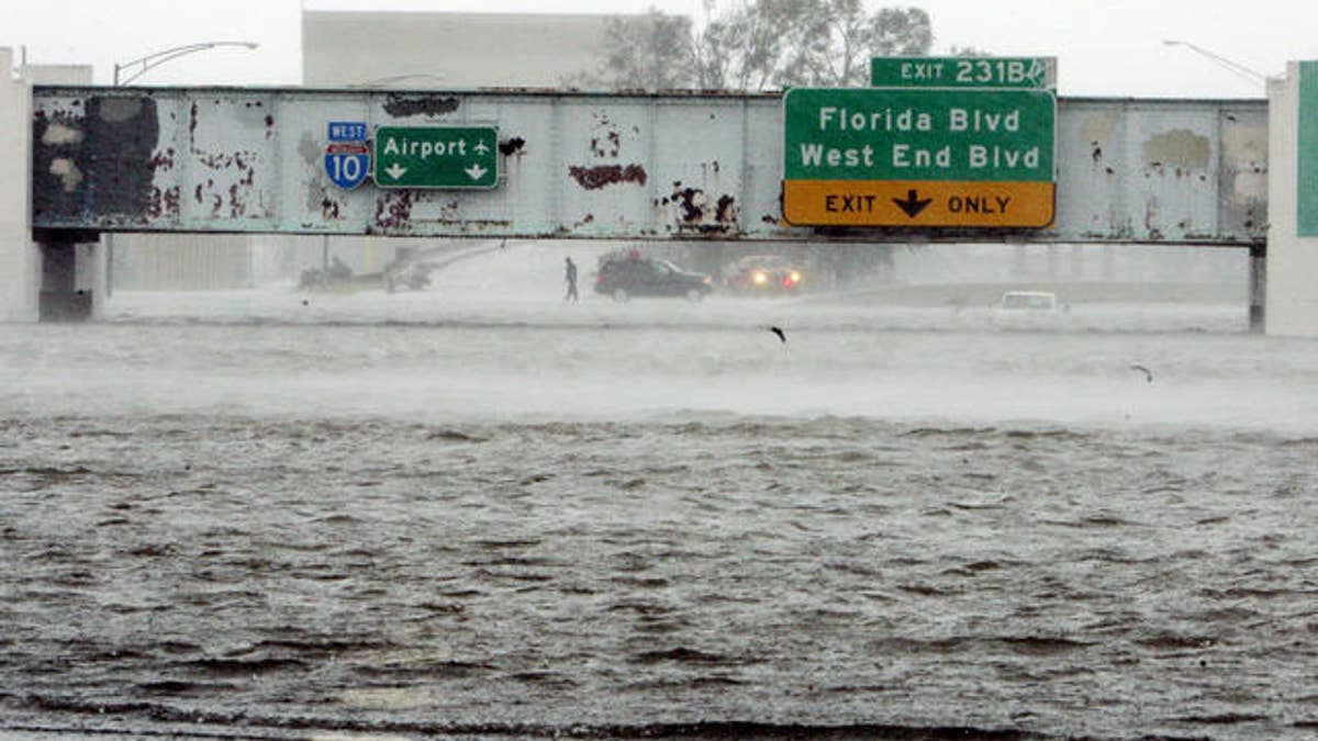 The Mound Underpass on Interstate-10 is flooded near downtown New Orleans on Monday, Aug. 29, 2005, as Hurricane Katrina dumped torrential rain and battered the city when it made landfall near Grand Isle. (AP Photo/Bill Haber)