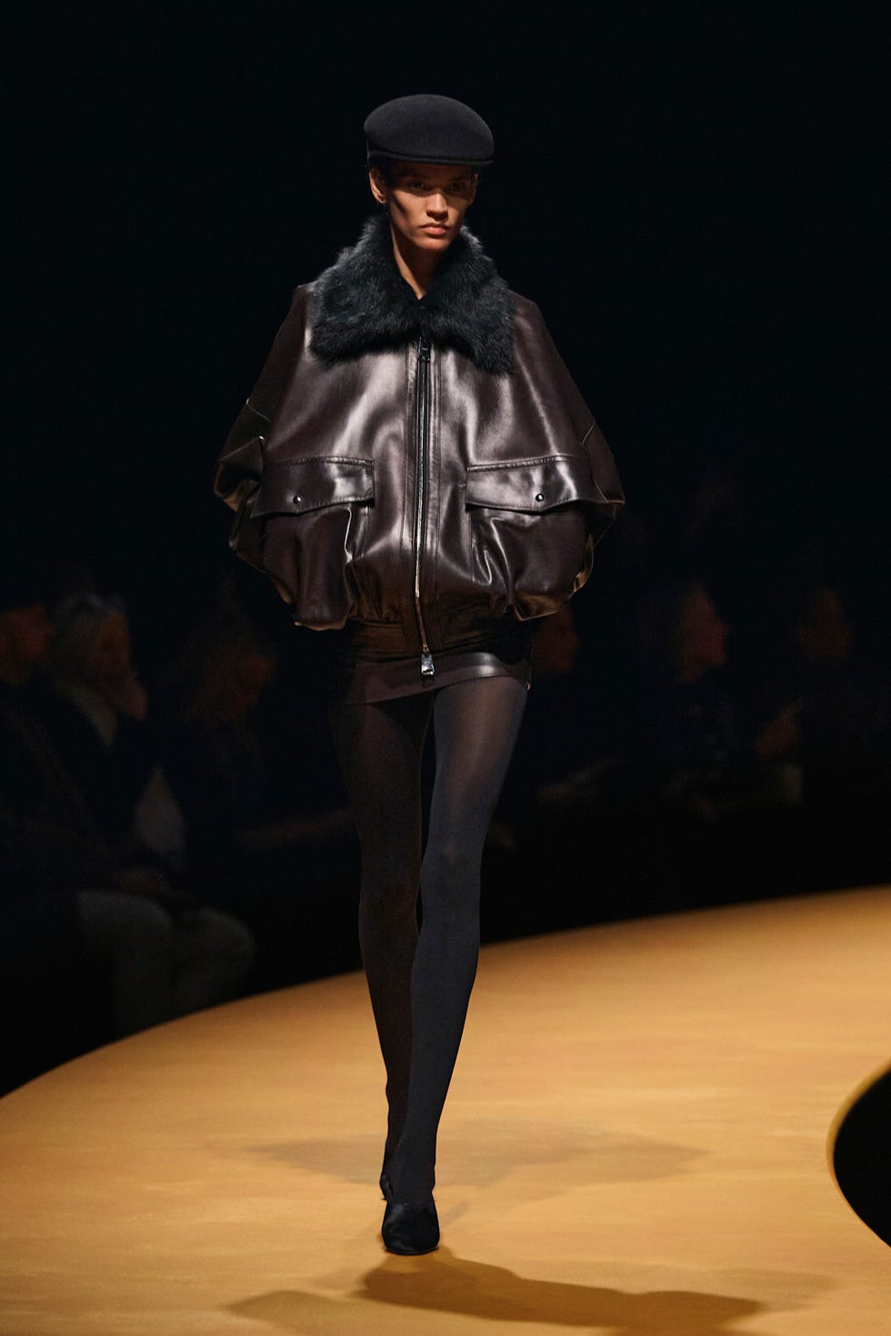 fashion model showcasing a statement outfit on a runway
