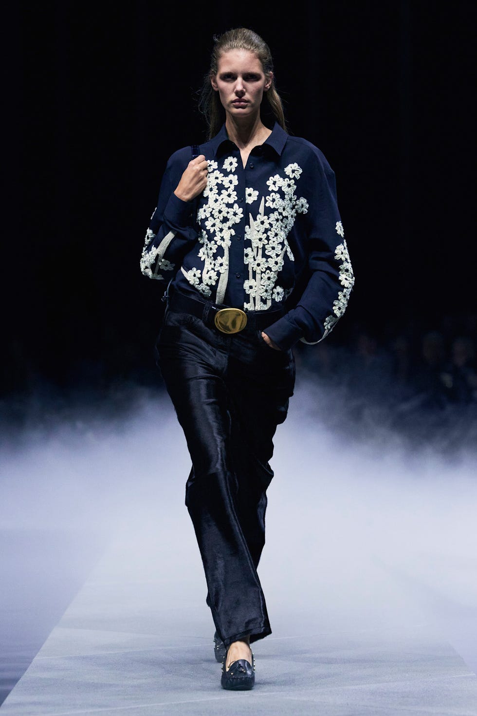 fashion runway model showcasing embroidered clothing