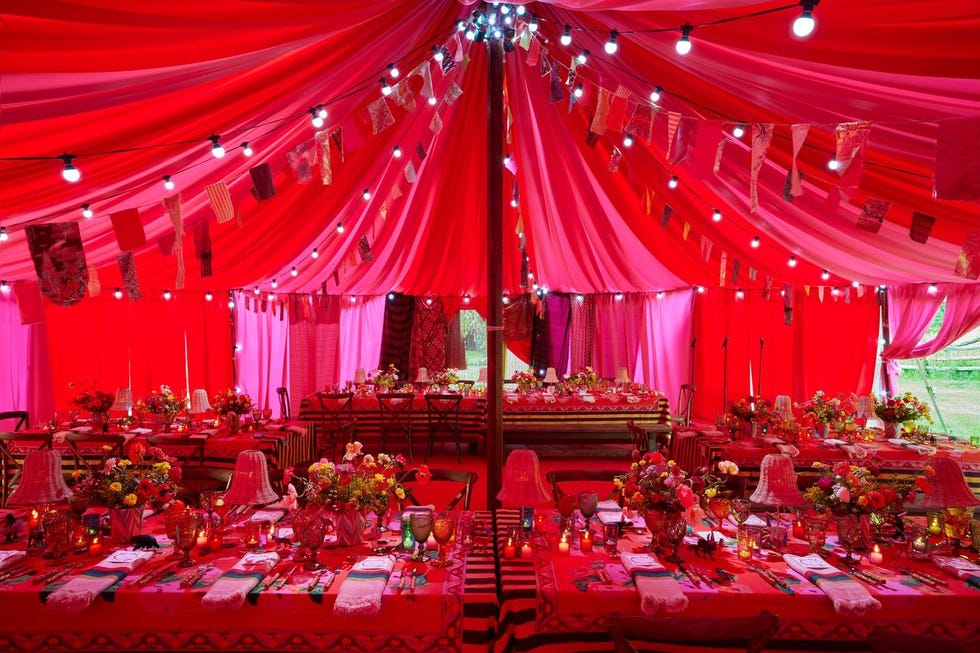 a lavish party setup under a pink tent