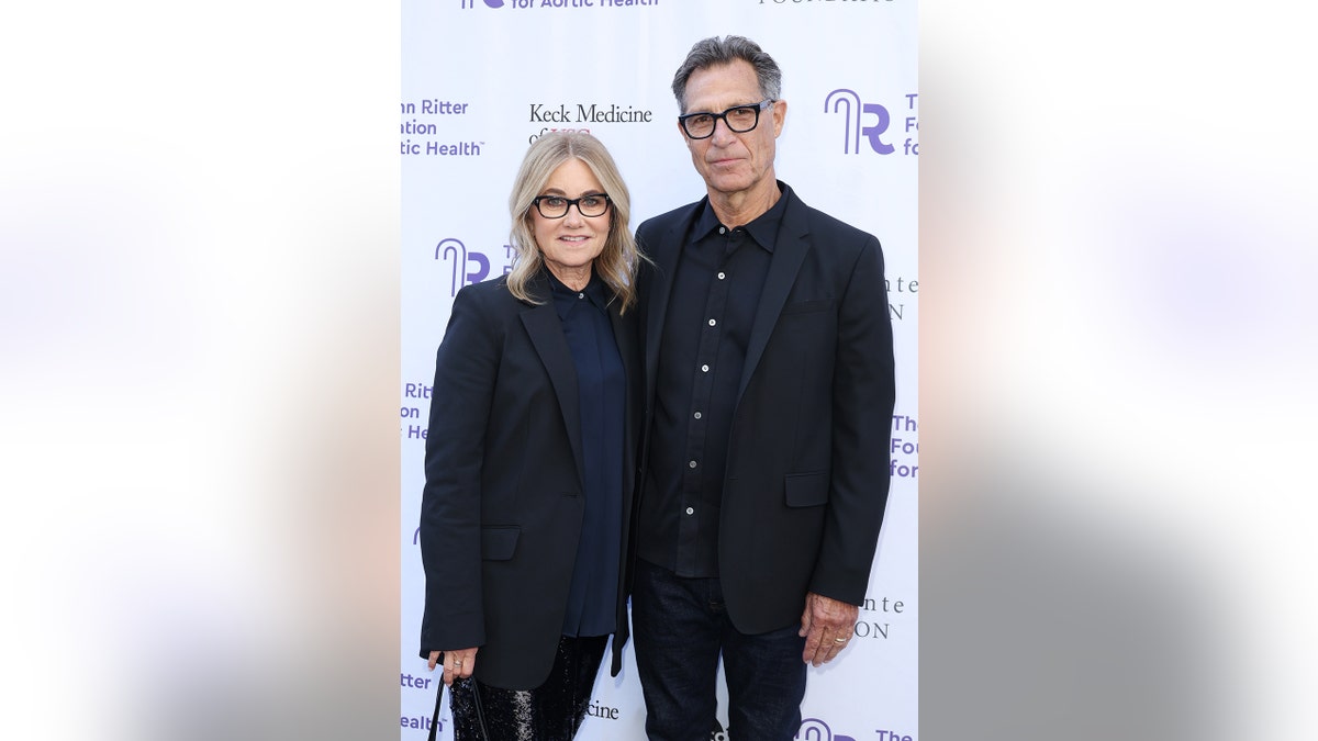 Maureen McCormick and her husband Michael Cummings wearing matching attire.
