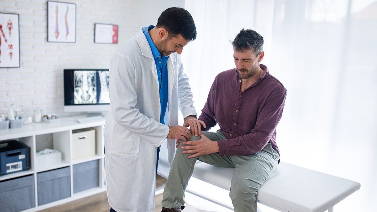 orthopedist checking patient's knee