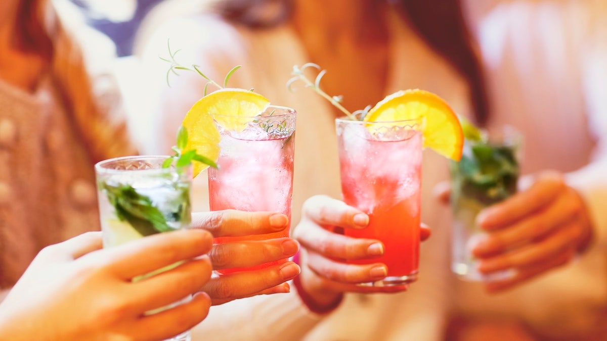 People toasting with cocktails