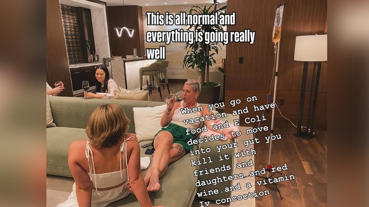 Singer Pink drinks wine while receiving fluids.