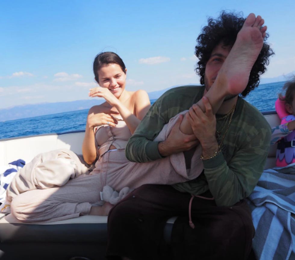 individuals relaxing on a boat with a stunning water backdrop