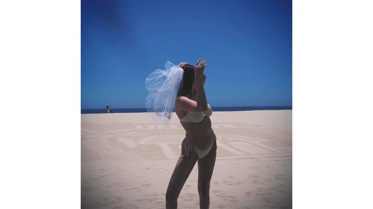 Selena Gomez poses in a white bikini
