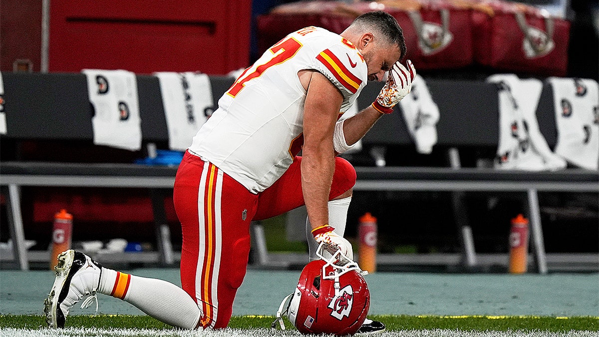 Travis Kelce kneels
