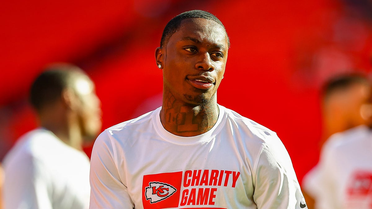Xavier Worthy looks on during pregame