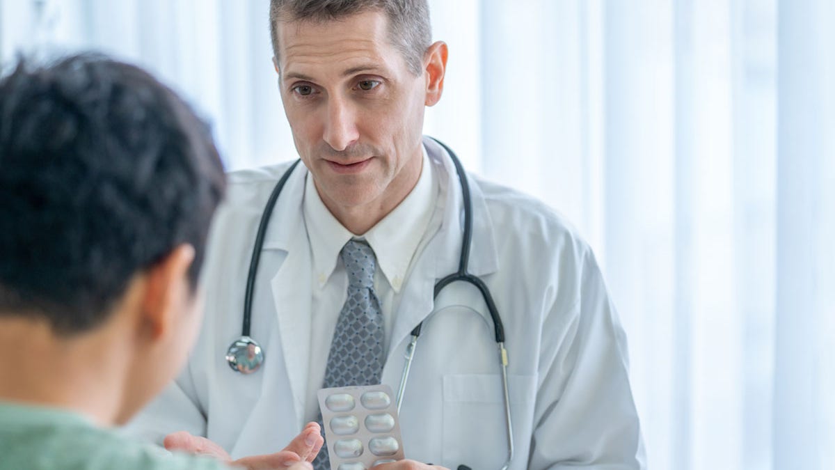 Man at doctor getting medication for diabetes