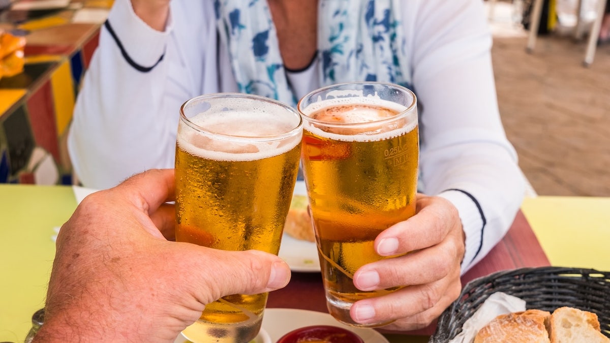 Couple toasting with beer
