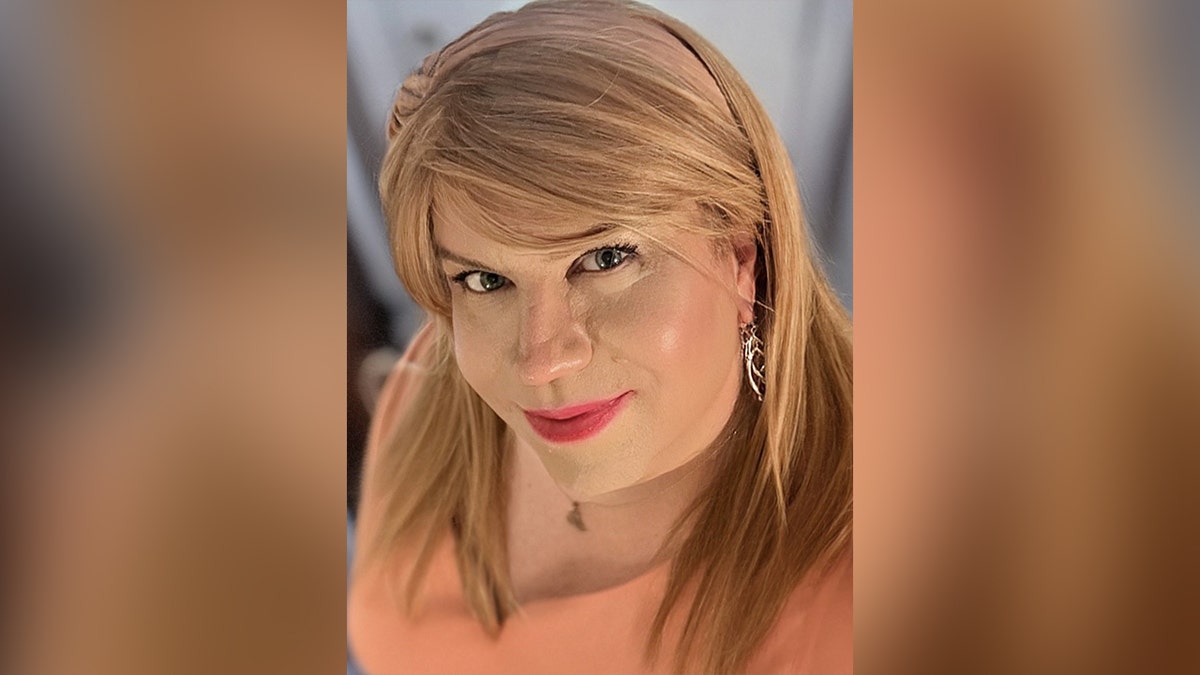 transgender woman with blonde wig and makeup